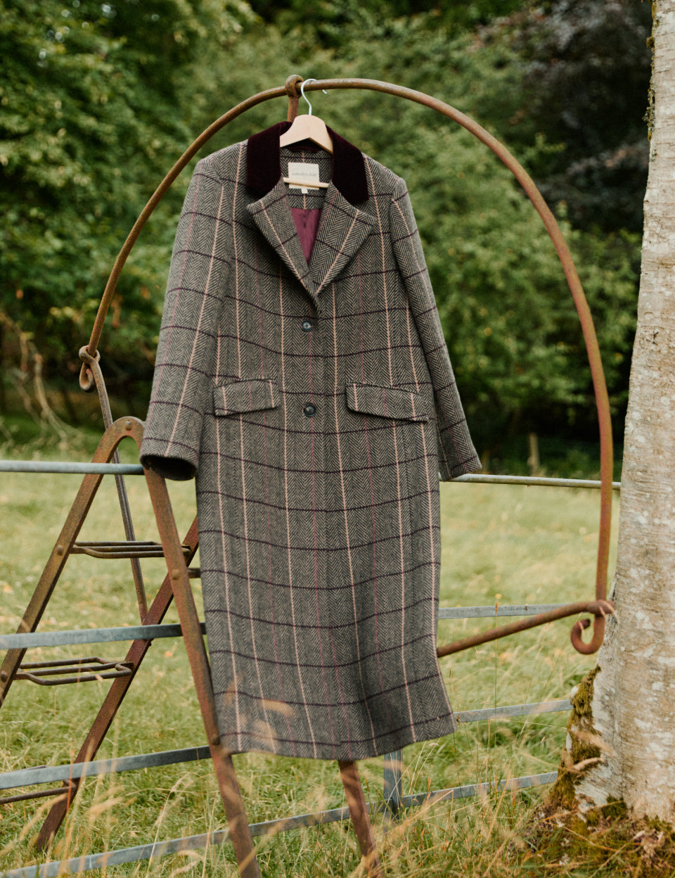Brown herringbone wool-blend coat on a hanger