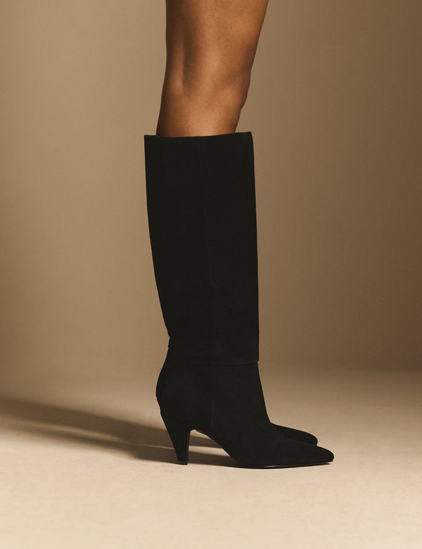 Side view of black suede knee-high boots