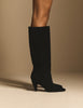 Side view of black suede knee-high boots