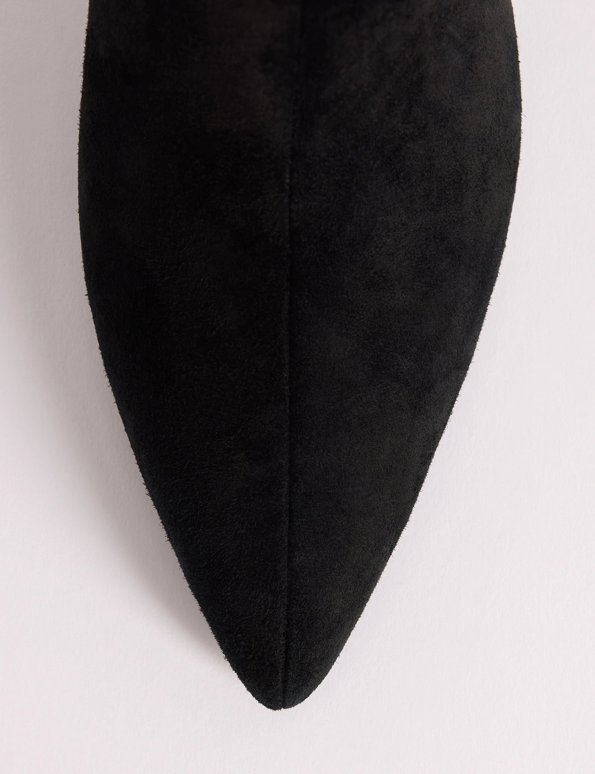 Pointed toe detail on black suede knee-high boots