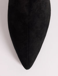 Pointed toe detail on black suede knee-high boots