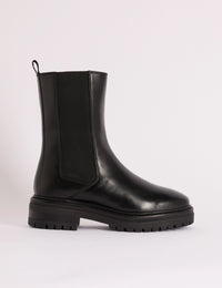 Side view of black leather Chelsea boot with chunky sole