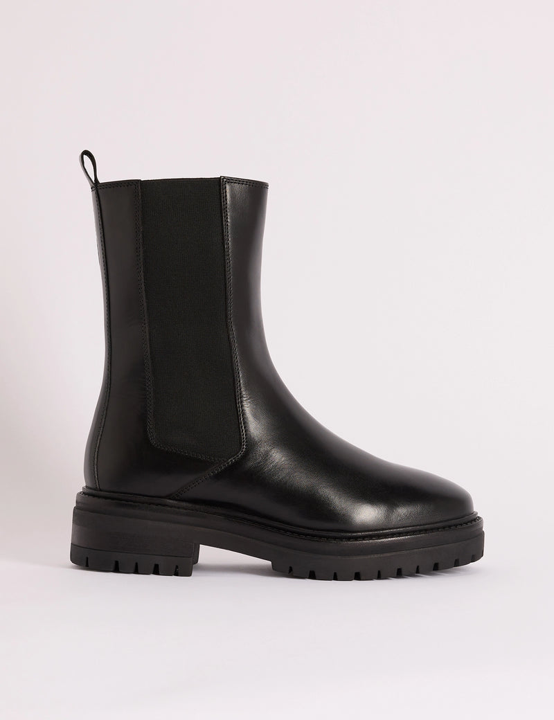 Side view of black leather Chelsea boot with chunky sole