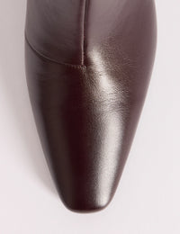 Chisel toe detail on brown leather boots