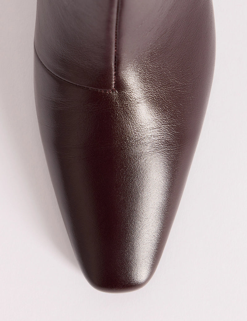 Chisel toe detail on brown leather boots