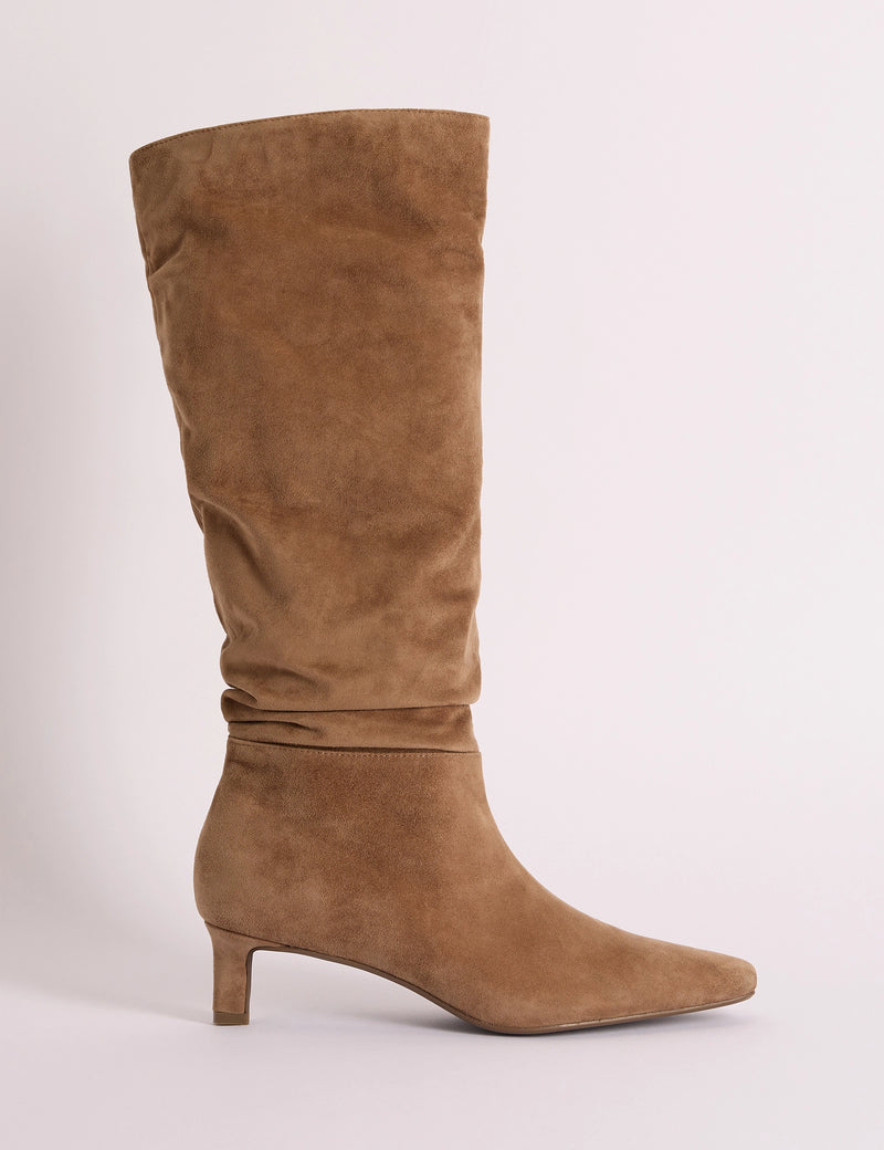 Side view of tan suede slouch knee-high boot