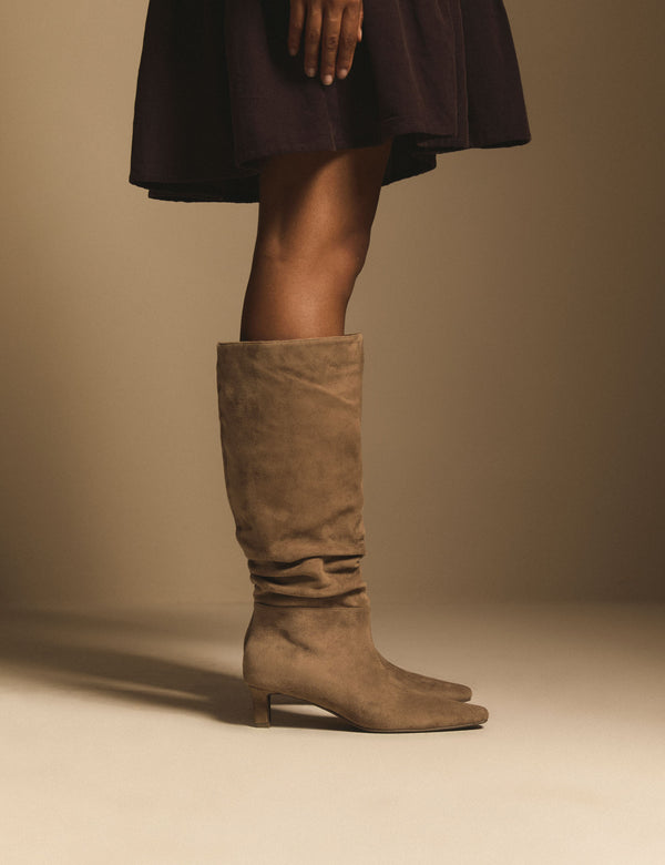 Side view of tan slouch knee-high boots