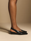 Side view of black leather wedge slingback heels