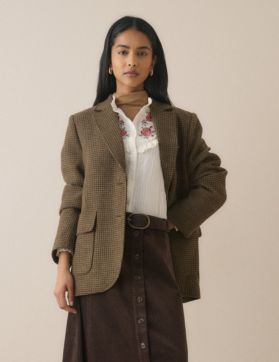 Cream embroidered blouse styled under a blazer