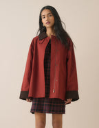 Red barn coat with brown cord collar and cuffs