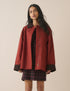 Red barn coat with brown cord collar and cuffs