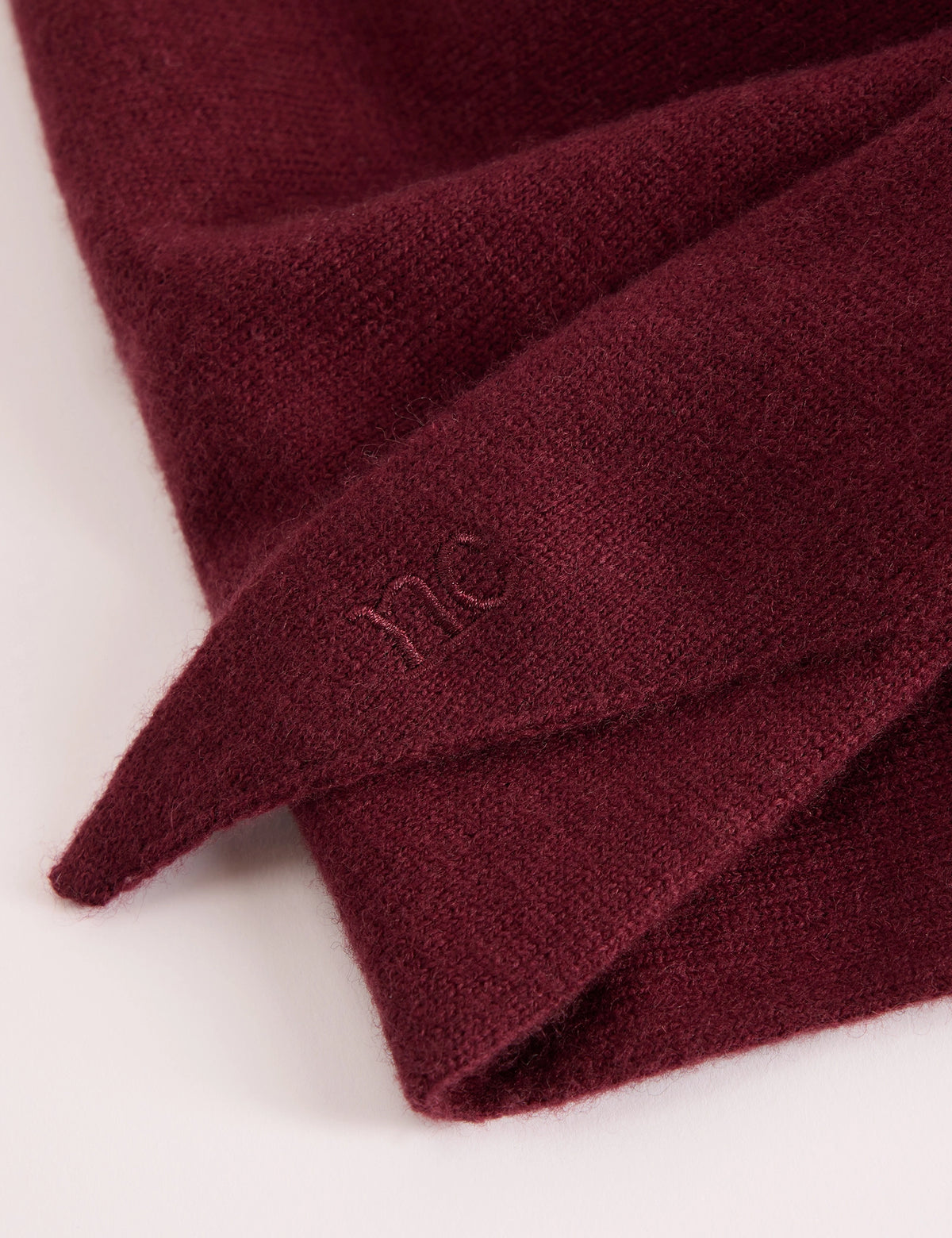 Embroidered logo detail on burgundy wool-blend scarf