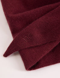 Embroidered logo detail on burgundy wool-blend scarf