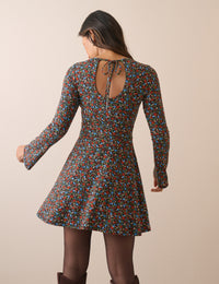 Back of black floral mini dress with keyhole tie