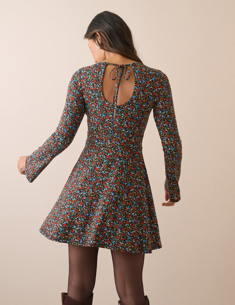 Back of black floral mini dress with keyhole tie
