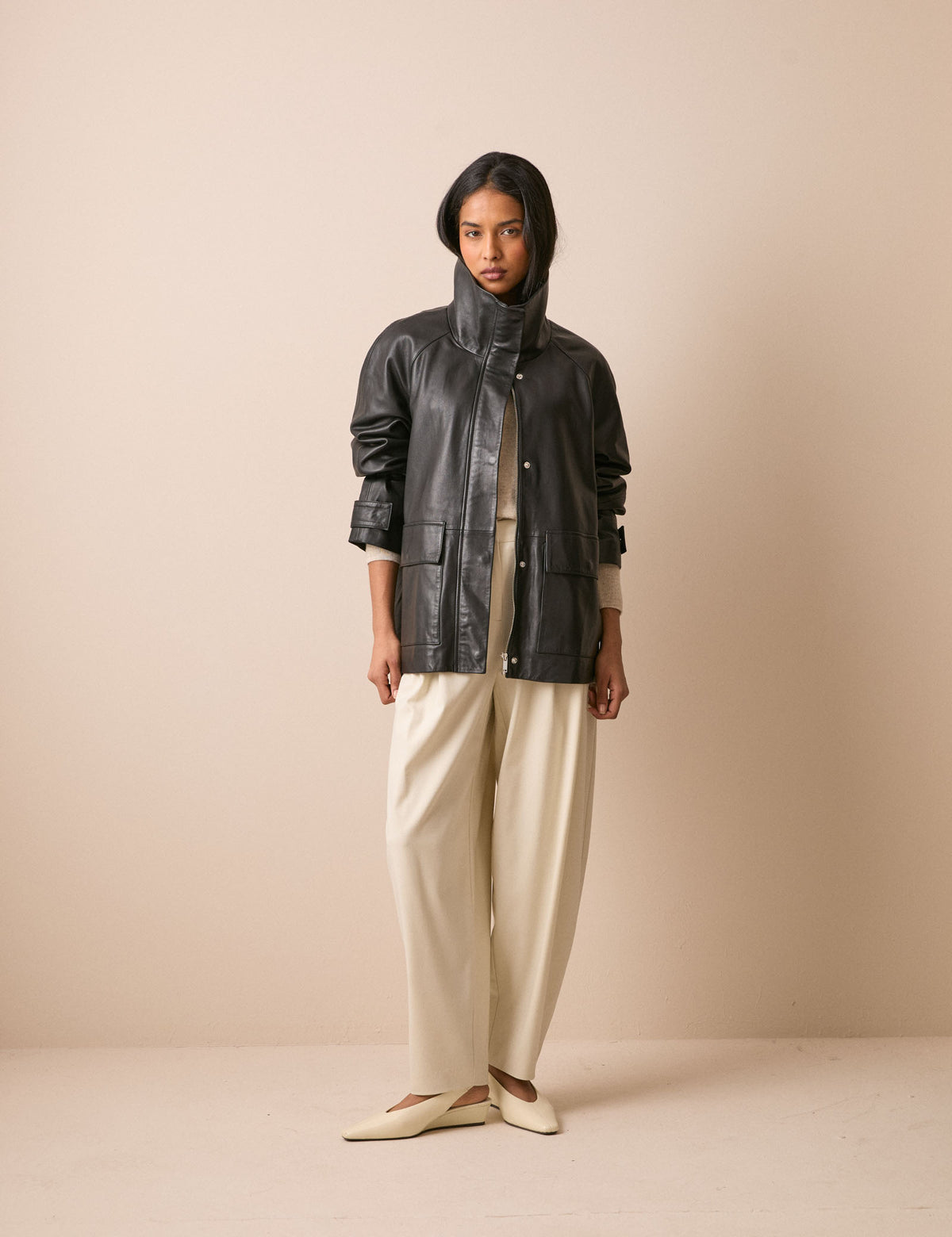 Black leather funnel neck jacket with flap pockets