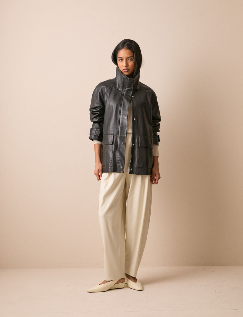 Black leather funnel neck jacket with flap pockets
