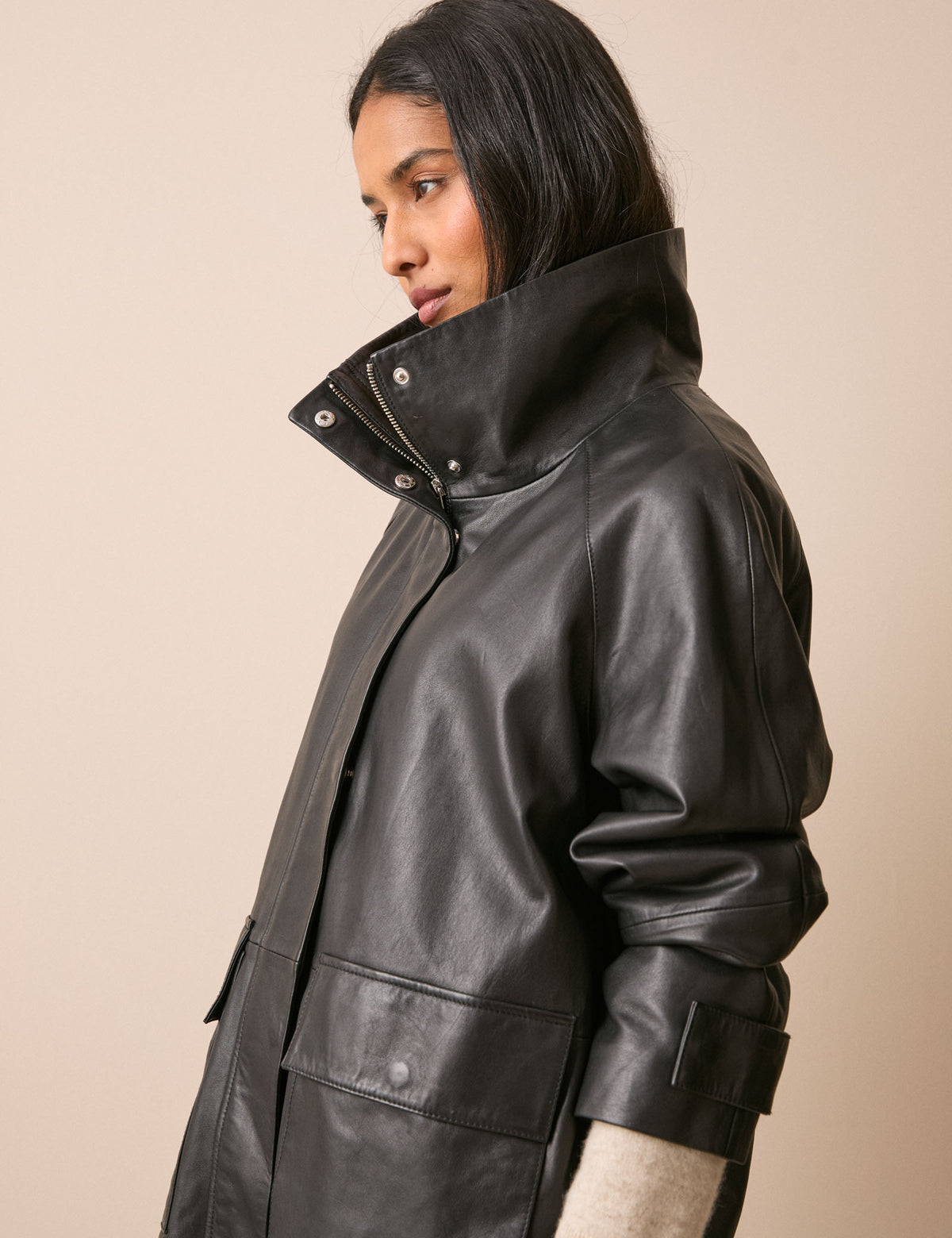 Side view of black leather funnel neck jacket