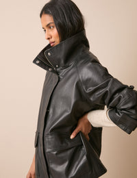 Side view of black leather funnel neck jacket