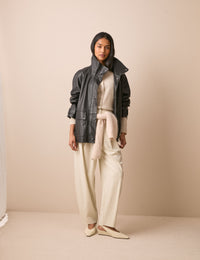 Front view of black leather funnel neck jacket
