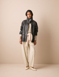 Front view of black leather funnel neck jacket