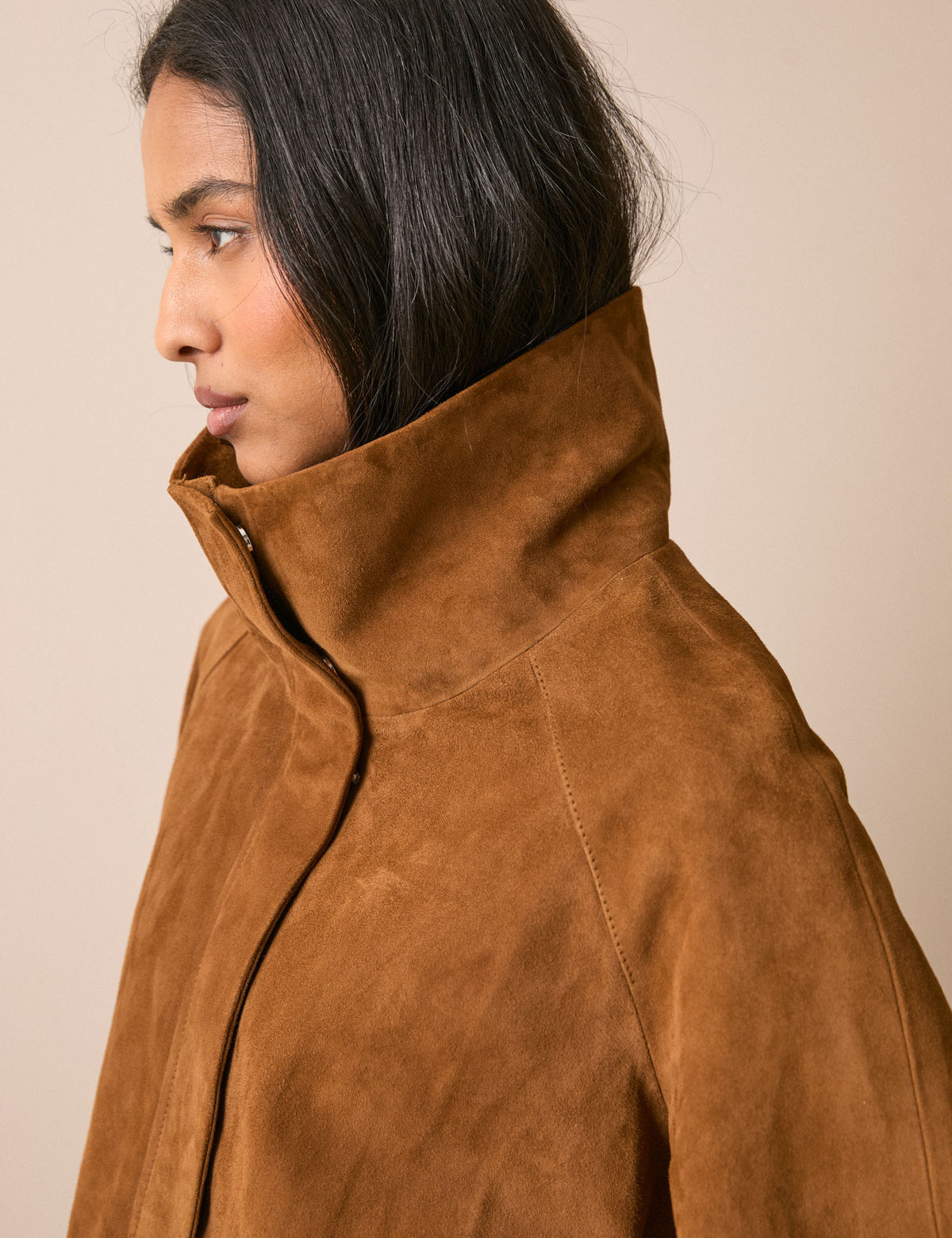 Funnel neck detail on tan suede jacket