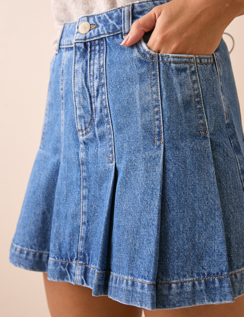 Pleat detail on mid wash blue denim mini skirt