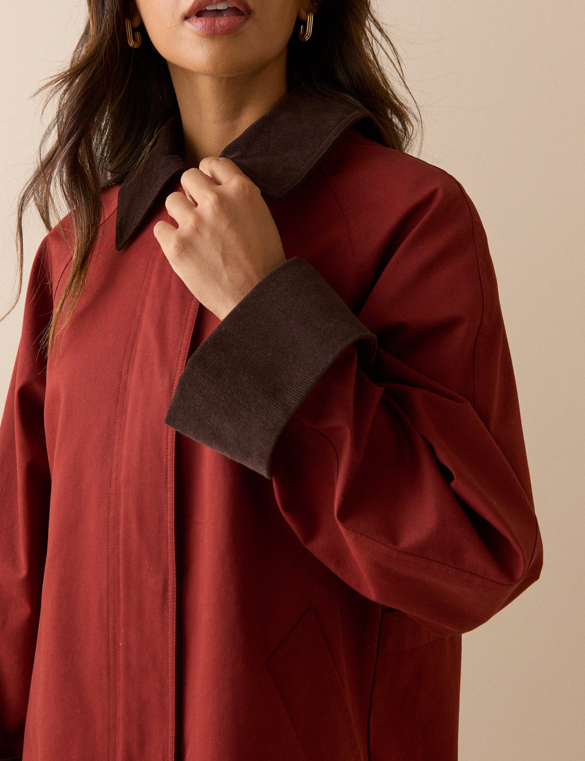 Brown cord collar and cuff detail on red barn coat