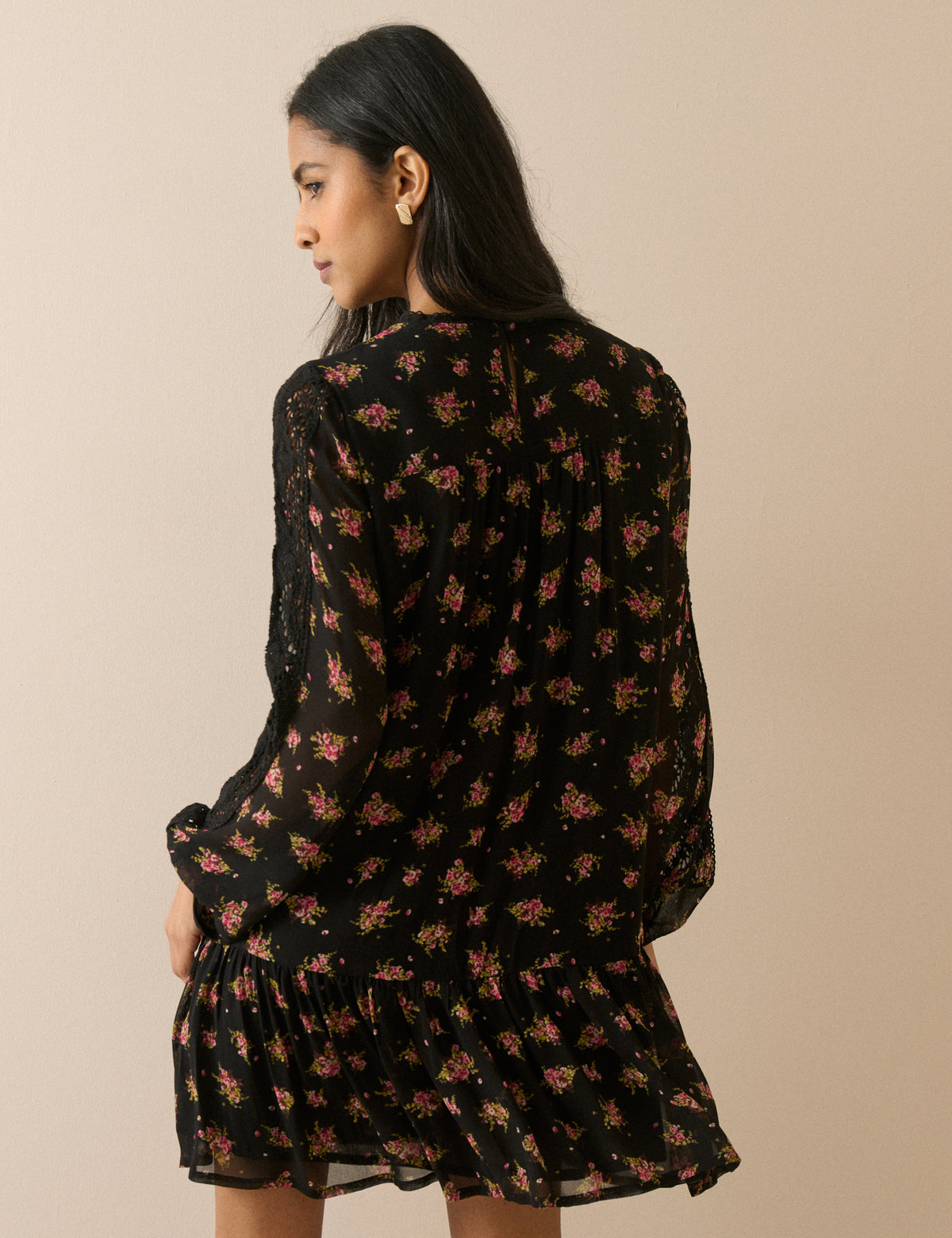 Back of black floral long sleeve mini dress