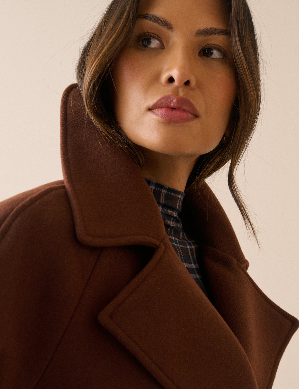 Collar detail on brown wool-blend pea coat