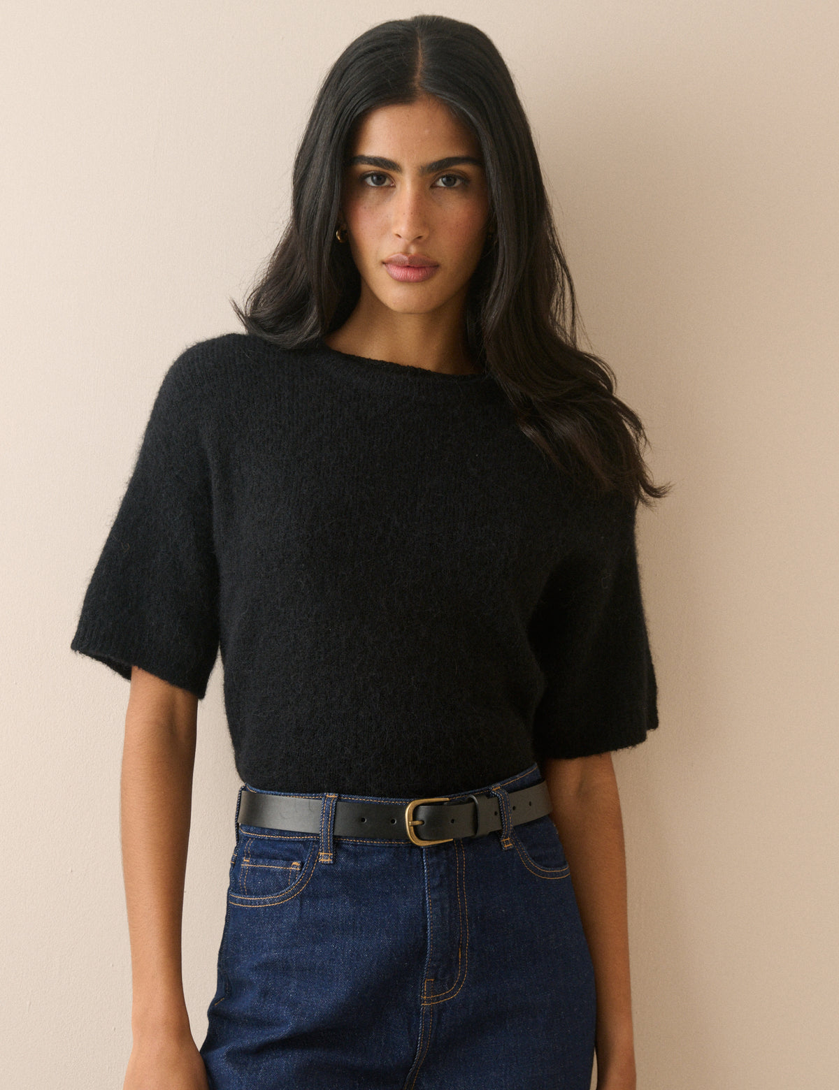 Black leather belt with gold buckle styled with jeans