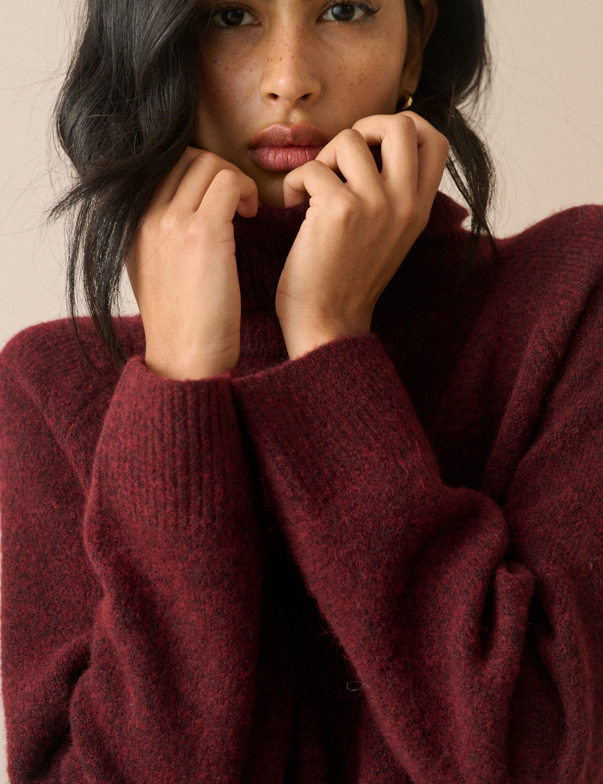 Roll-neck detail on burgundy jumper