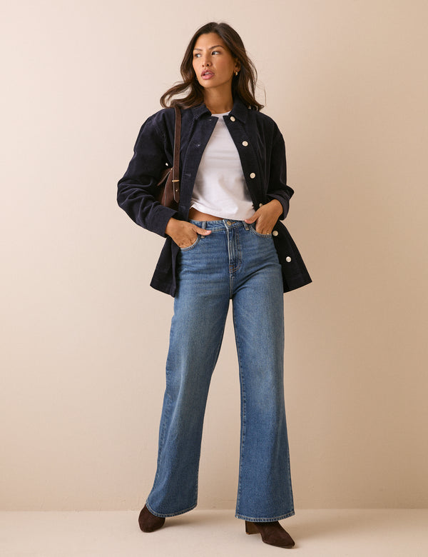 Front view of navy cord shacket styled with jeans