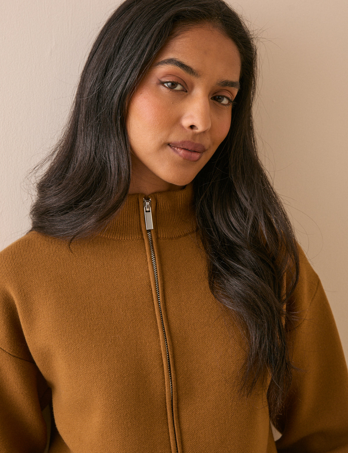 High neck zip detail on camel knitted jacket