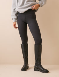 Front view of black high-waisted jersey leggings