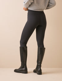 Back view of black high waisted jersey leggings