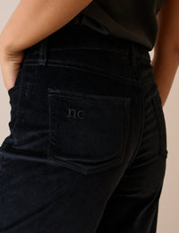 Back pocket detail on black velvet jeans